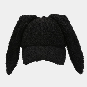 Close-up of the fluffy black lamb wool texture and long bunny ears on the baseball cap