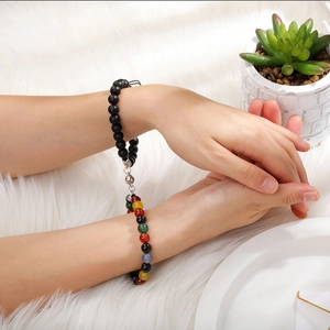 Close-up of magnetic coupling feature between matte black and colorful stone bracelets