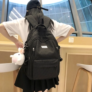 Black quilted bubble backpack with cute white plush bunny charm for high school students