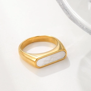 Golden minimalist ring with rectangular white marble shell inlay on a smooth wide band