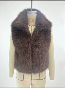 Close-up of thick dark brown faux fox fur vest showing the dense hair texture on mannequin