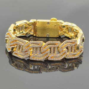 Macro shot of 16mm gold hip hop chain links with white rhinestones and folding clasp