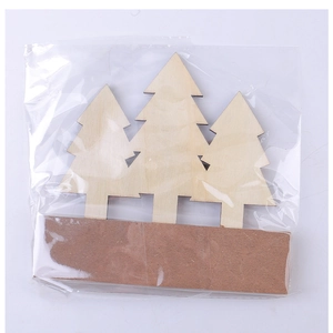 Detail of wooden Christmas tree tabletop ornaments packed in clear protective bags