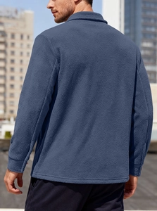 Detail of navy blue fleece tactical shirt showing soft fabric texture and cuff button