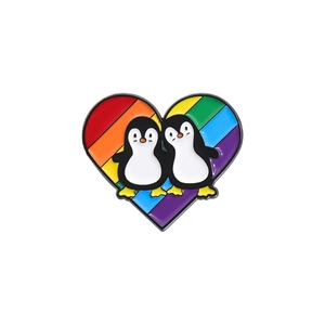 Creative heart shaped enamel pin featuring cartoon penguins and vibrant rainbow stripes