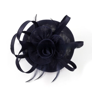 Detail of navy blue fascinator headpiece featuring mesh petals and soft feather accents