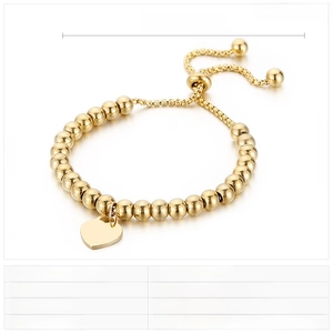 Detail of adjustable gold stainless steel beaded bracelet with polished heart charm