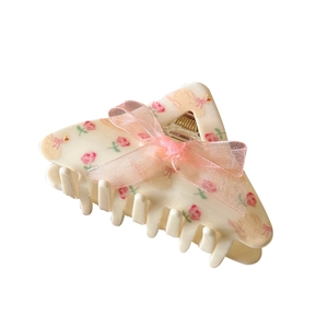 Cream-colored floral shark hair clip with a pink mesh bow and swan pattern prints