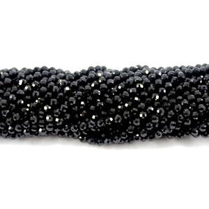 Natural black spinel faceted round loose beads for DIY jewelry making on white background