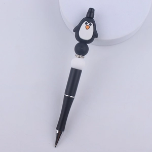 Macro detail of cartoon penguin silicone bead pen with shimmering rhinestone spacers