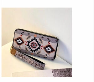 Detail view of ethnic geometric pattern wallet with matching wrist strap and zip closure