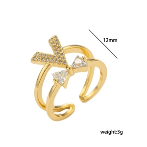 Detail view of adjustable gold V-shape ring with bow and crystals, 12mm width and 3g weight