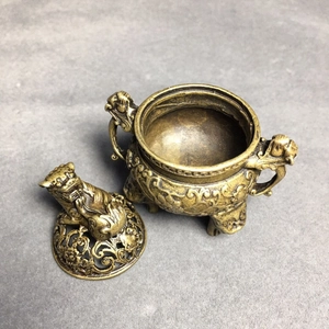 Close-up of vintage bronze incense burner with carved lid and traditional cloud patterns