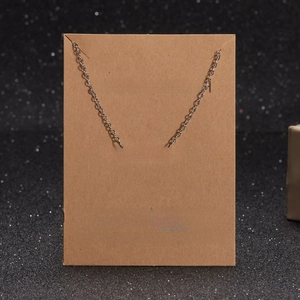 Detailed view of silver Mama pendant necklace on a MAKE A WISH gift card background