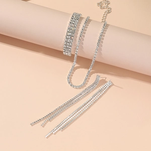 Detail view of silver rhinestone jewelry set with tassel earrings and crystal necklace
