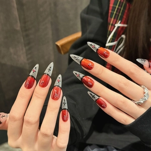 Gothic red and black stiletto press-on nails with cross patterns and 3D micro beads