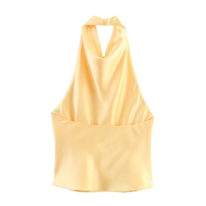 Detail of yellow satin halter top showing silk-like texture and glossy fabric finish