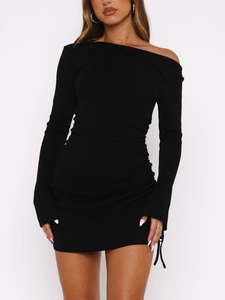 Close-up of black ribbed knit mini dress with off-shoulder design and side drawstring