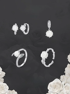 Collection of white rose jewelry including earrings, pendant and rose-snake open ring