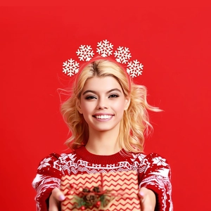 Close-up of festive red Christmas headband featuring white snowflake design on a model