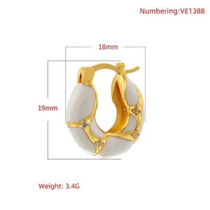 Irregular U-shaped lava earrings in gold and white enamel with cubic zirconia accents