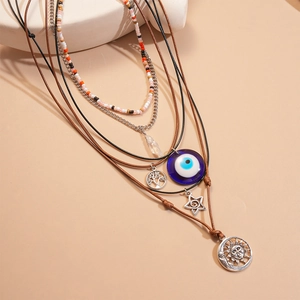 Bohemian multi-layer necklace set with evil eye, tree of life, and sun moon pendants