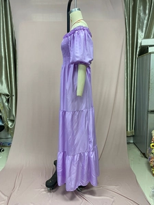 Detail of lavender satin tiered dress with elastic smocking and off-shoulder puff sleeves