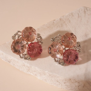 Macro detail of pink resin flower earrings with sparkling rhinestones and silver base