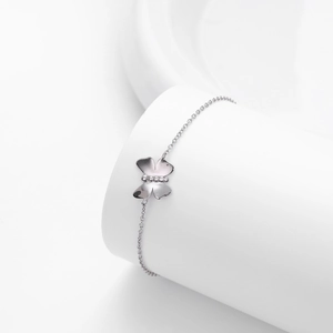 Detailed view of an elegant S925 silver butterfly bracelet on a white display pedestal
