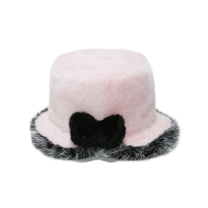 Close-up of pink faux fur bucket hat featuring a large black bow and soft plush texture
