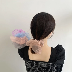 Polka dot mesh lace scrunchies in multiple pastel colors shown in a stylish hairstyle