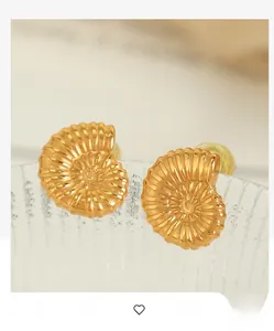 Macro shot of 18K gold plated shell-inspired stud earrings with spiral textured finish