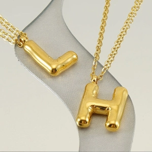 Fashionable gold bubble initial pendant necklaces with 3D bubble letters L and H