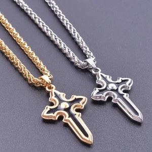 Detail of gothic sword cross pendants in gold and silver finish with black enamel inlays