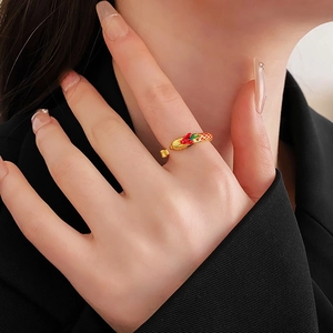 Detail of an adjustable gold ring with dragon and phoenix enamel in traditional style