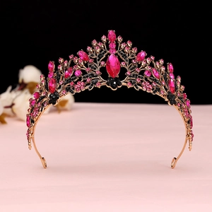 Detailed view of Baroque crown with pink and black crystals on gold alloy frame