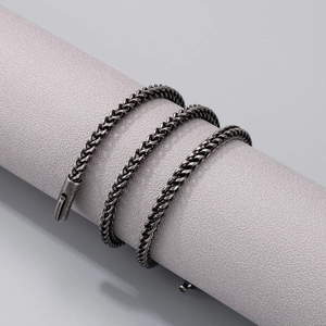 Men's vintage oxidized silver stainless steel foxtail chain necklace on a display stand