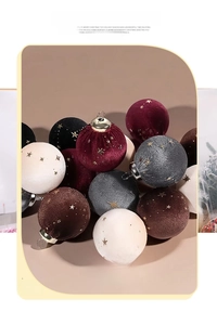 Close-up of velvet Christmas ball ornaments with gold star prints and hanging loops