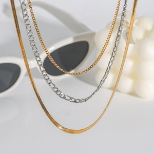 Three-layer layered necklace with 18K gold and silver snake and Figaro chains