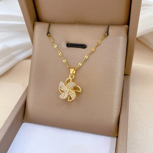 Detail view of rotating windmill necklace with crystals in a luxury velvet gift box