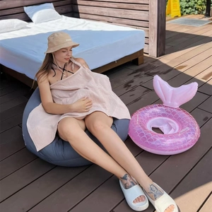 Detail of soft pink cotton muslin nursing cover used as a lightweight baby stroller blanket