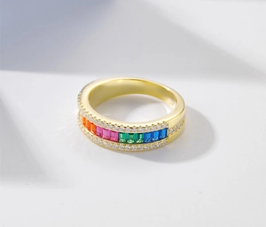 Macro detail of gold rainbow ring with rectangular colored stones and micro-pave diamonds
