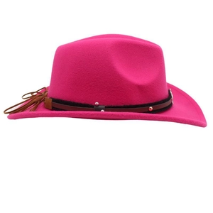 Detail of rose red felt cowboy hat with decorative riveted belt and fringe trim