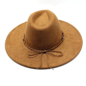 Detail of dark brown wide-brimmed fedora with woven rope and beaded bow decoration