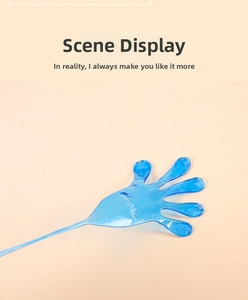 Close-up of translucent blue stretchy sticky hand toy with long elastic string on yellow background