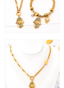 Detail of gold Hamsa Hand necklace and bracelet set with colorful Evil Eye accents