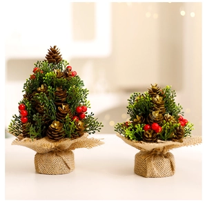 Detail of mini Christmas trees with pine cones, red berries and burlap wrapped bases