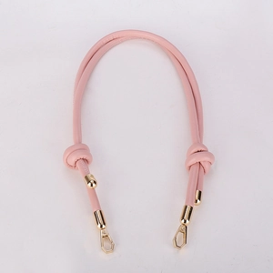 Pink PU leather shoulder strap detail featuring gold metal buckles and a knotted design