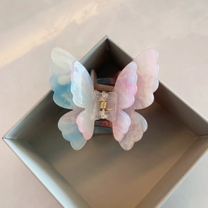 Elegant 3D butterfly hair claw with blue pink gradient marble texture and gold spring