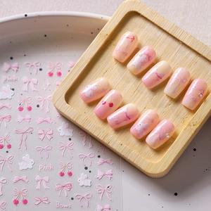 Pink bow and cherry 3D nail art stickers with matte texture for feminine manicure styling